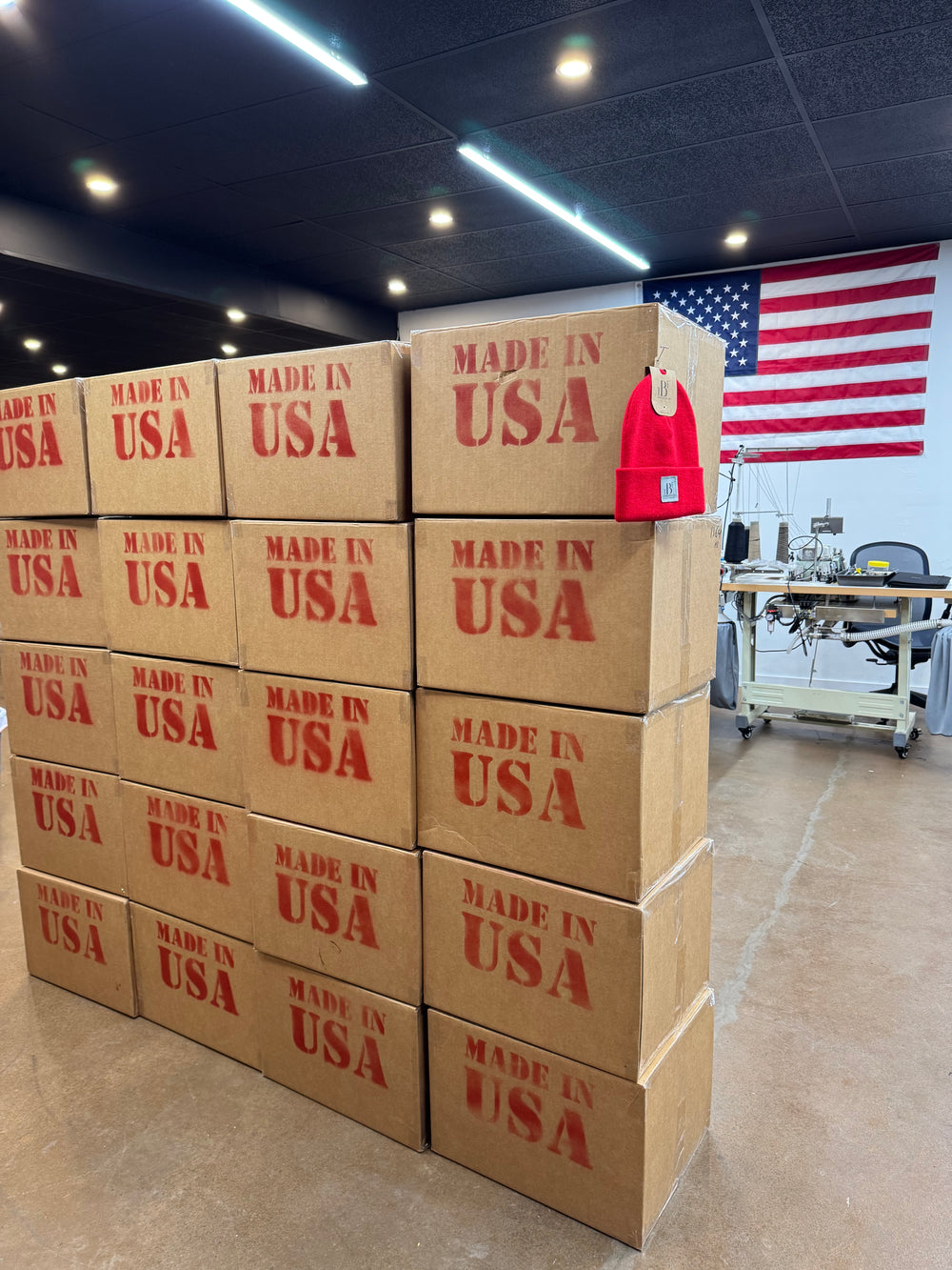 Stack of 'Made in USA' boxes with an American flag in the background