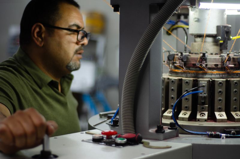 Person working with machinery in The Beanie Factory.